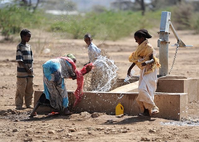 File:Ethiopian women and boys playing with water.jpg