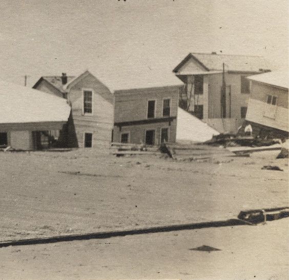 File:Cluster of houses submerged in sand.jpg