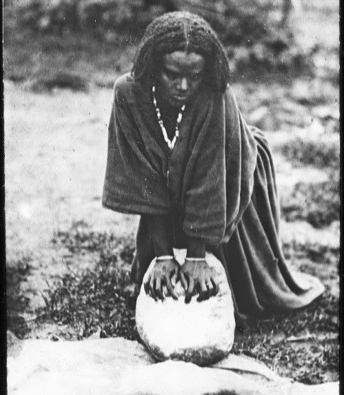 File:Arsi girl making flour in Ethiopia.jpg