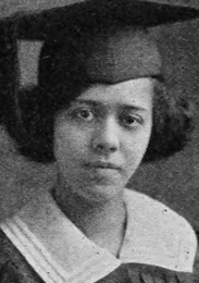 The face of a young African-American woman wearing a cap and gown.