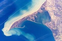 Long Point Peninsula with bright sediment plumes. (The top of the image points southwest, rather than north.) Source: NASA