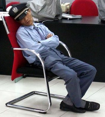 File:Bank-Security-Guard-Sleeping-Cropped.jpeg