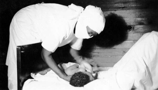 File:Midwife with a newborn infant (8771281412).jpg