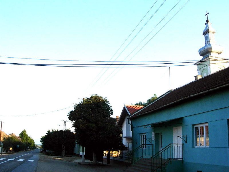 File:Straža, main street and Romanian Orthodox church.jpg