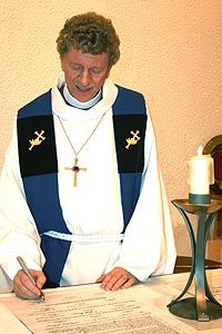 File:Bishop-signing-covenant.jpg