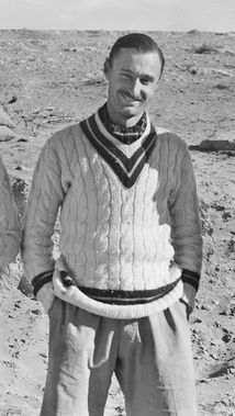 Informal portrait of Gordon Steege in cricket blazer with hands in pockets