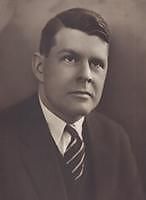 A black-and-white photographic portrait of a middle-aged Lee from the shoulders up, wearing a suit