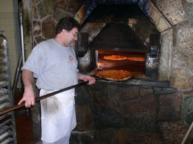 File:Pizza baking in brick oven, New Haven.jpg