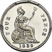 Silver coin with a design featuring a seated, armored woman