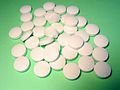 Round, biconvex white tablets