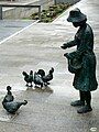 Woman with chickens and remains of the ramparts.