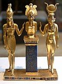 Osiris on a lapis lazuli pillar in the middle, flanked by Horus on the left, and Isis on the right; 875–850 BC; gold and lapis lazuli; 9 cm; Louvre