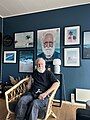 Sven Yrvind sitting beneath the film poster for Philosopher of the Sea.