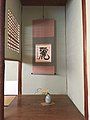 Floral arrangement (chabana) and calligraphic hanging scroll (kakemono) in the alcove of a tea room