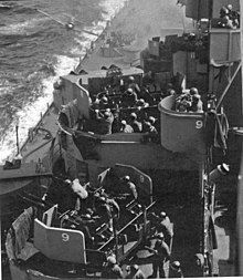 Diving airplane about to hit the side of a warship