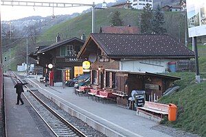 Two two-story buildings with gabled roof on a platform