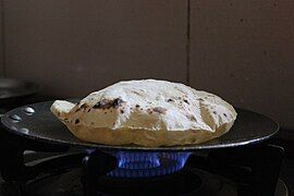 A roti being baked on a tava