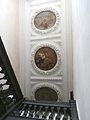 Great Potheridge House, staircase ceiling c.1660-70 with plasterwork wreaths enclosing allegorical paintings with putti, one riding on the back of an eagle holding a crown in its talons, the middle one of a bare breasted female