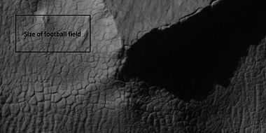 Close view of high center polygons near glacier, as seen by HiRISE under the HiWish program. Box shows size of football field.