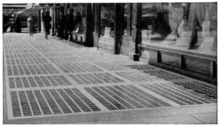 Armoured vault lights installed in the sidewalk outside a store