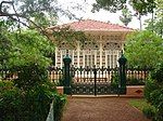 A building with elaborate facade behind a metal fence