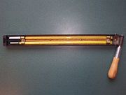 A sling psychrometer, showing the "wet bulb" on top. The muslin sleeve, pictured here, is used at temperatures above −10 °C (14 °F) and when the temperature is colder then a thin layer of ice is formed on the bulb.