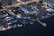 Aerial nighttime view of multiple buildings and an outdoor stage