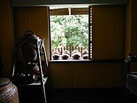 Banggéra at the Rizal Shrine in Calamba, Laguna which contains many palayok, a traditional earthenware pot used for cooking