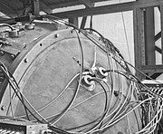 Closeup of a detonator set. The EBW is the Y-shaped device with two wires coming in at angles along the surface. The larger round objects with two wires coming out perpendicular to the surface are diagnostic equipment.