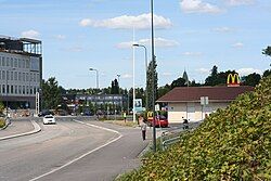 The town centre of Kirkkonummi in 2011. On the left, the town hall under construction, behind McDonald's the bell tower of St. Michael's Church.