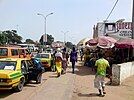 A street with cars and a sidewalk with