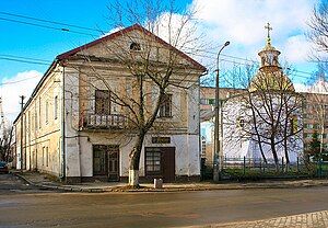 Two-story residence to the left of a church