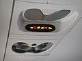 Passenger signs, lights, and vent nozzles on a Bombardier CRJ200. The speakers are ahead of the seat belt lights in this perspective, and the attendant call button is the oval button ahead of the reading lights.