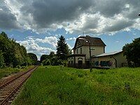 Former Booßen railway station, with the disused station building in the background