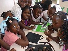 Photo of a group of children being introduced to a laptop