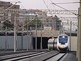 A high-speed train entering the station from the east.