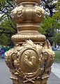 Detail of a lamppost in the square, featuring the Gallic rooster, national symbol of France.