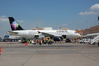 A Volaris Airbus A319 parked at Terminal 2 at Cancún International Airport