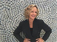 Artist Susan Sensemann, in 2018, in front of one of her paintings.