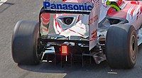 the rear of a Formula One car with a double decker diffuser located between the rear wheels