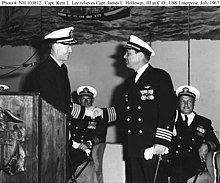 Capt. Kent Lee (left standing) taking command of the USS Enterprise