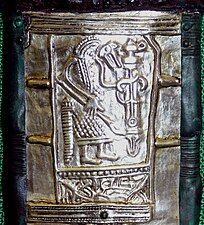 A wolf headed warrior on the Gutenstein scabbard [de].