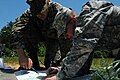 Soldiers from Bosnia and the Maryland Army National Guard plot out features on a map in order to complete a sand table for a combat lane exercise during training at Fort A.P. Hill, Va., June 15, 2012.