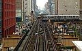 An Orange Line train (behind the turning train) at the northern end of the South Side Elevated branch