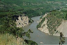 A river flowing through a vegetated canyon.