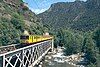 A train of the Ligne de Cerdagne crossing the river Têt near Villefranche de Conflent in 2002