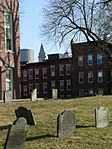 The Copp's Hill Burying Ground in the foreground with the Custom House Tower and One International Place glimpsed in the background.