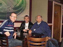 three people, sitting at a table