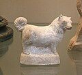 A terracotta figure of a small, fluffy dog, made in Italy in the 1st century BC – 1st AD.