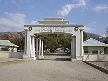 White gates with buildings behind them